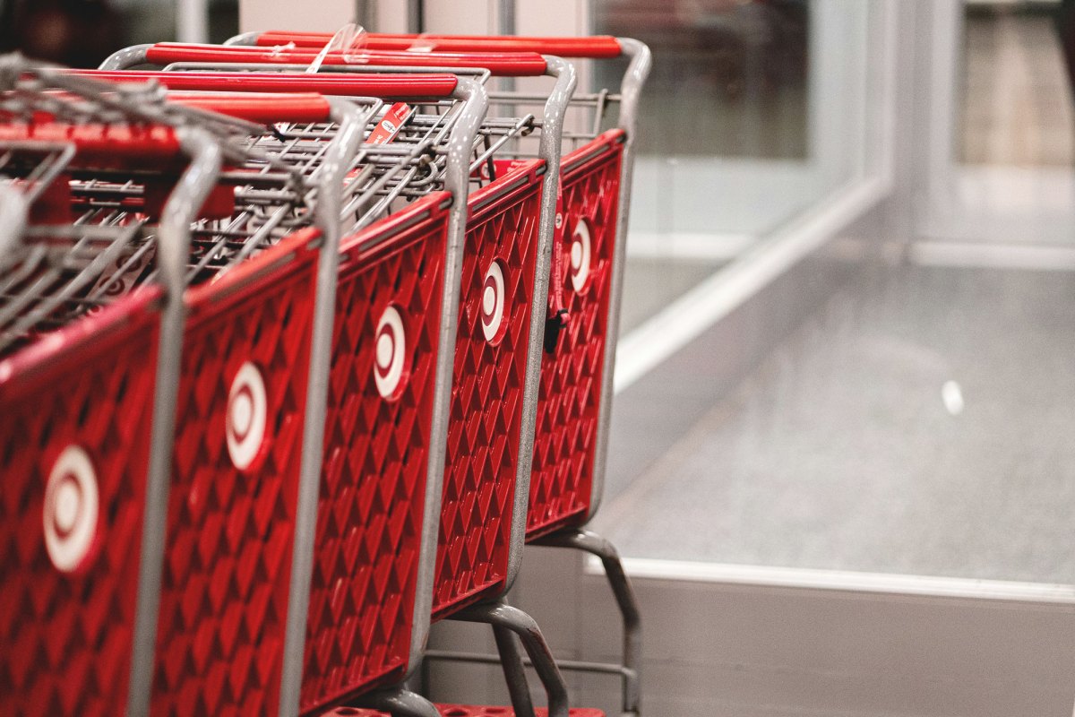 A row of red shopping carts sitting in front of a store