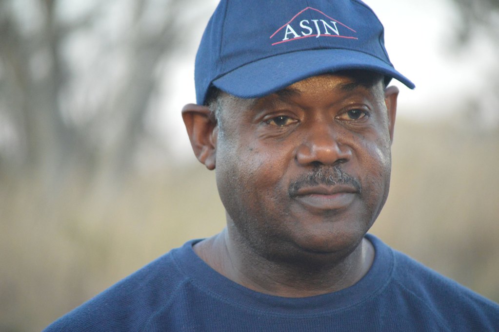 A man pictured with a blue hat and shirt