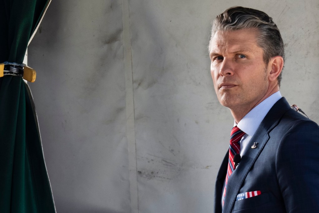 a photo of a man in a suit, pete hegseth, looking at the camera