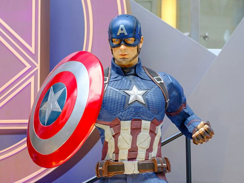 A model of the Marvel character Captain America, in a costume with a US Flag theme and large shield in one hand