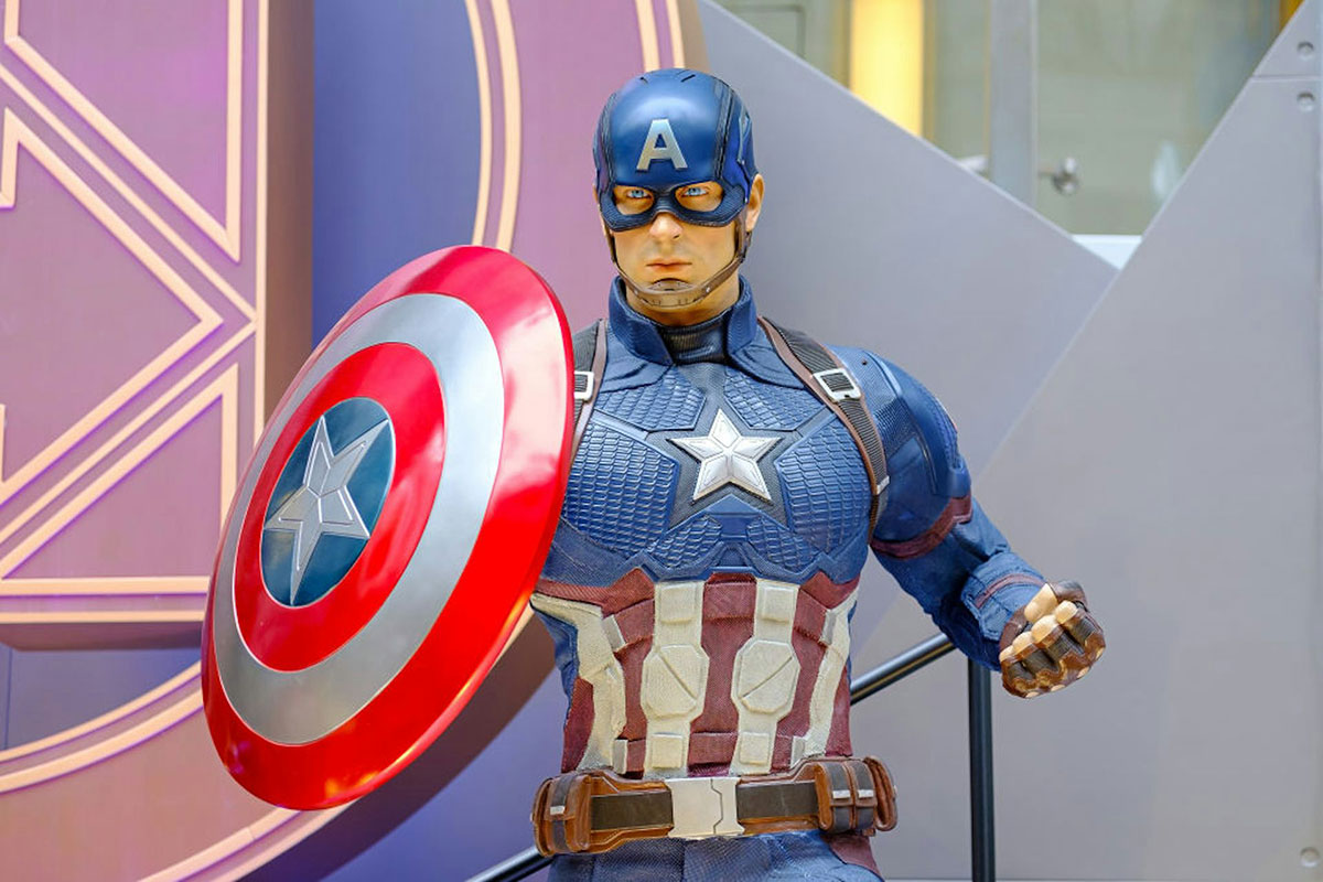 A model of the Marvel character Captain America, in a costume with a US Flag theme and large shield in one hand