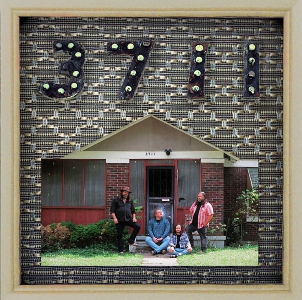 An album cover with stylized numbers '3711' across the top, and a photo of four men in front of a house below