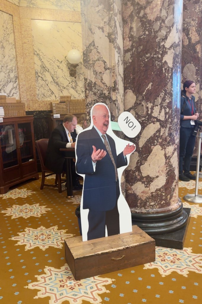 Cardboard cutout of a man wearing a suit with a speech bubble saying, āNoā