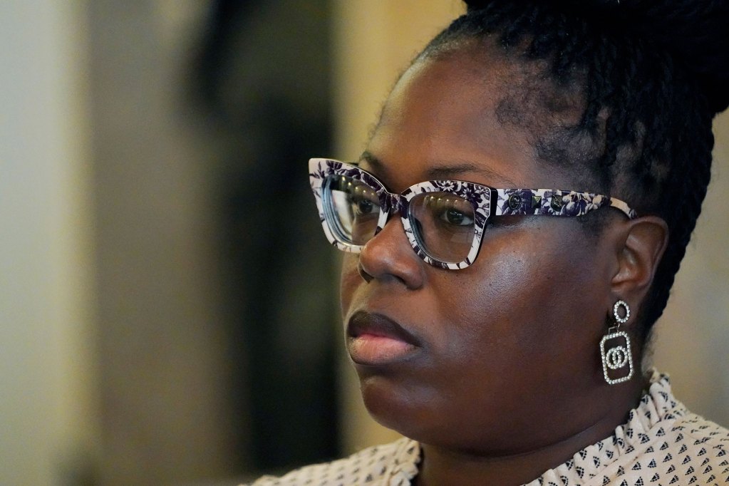 A woman wearing floral print black and white glasses