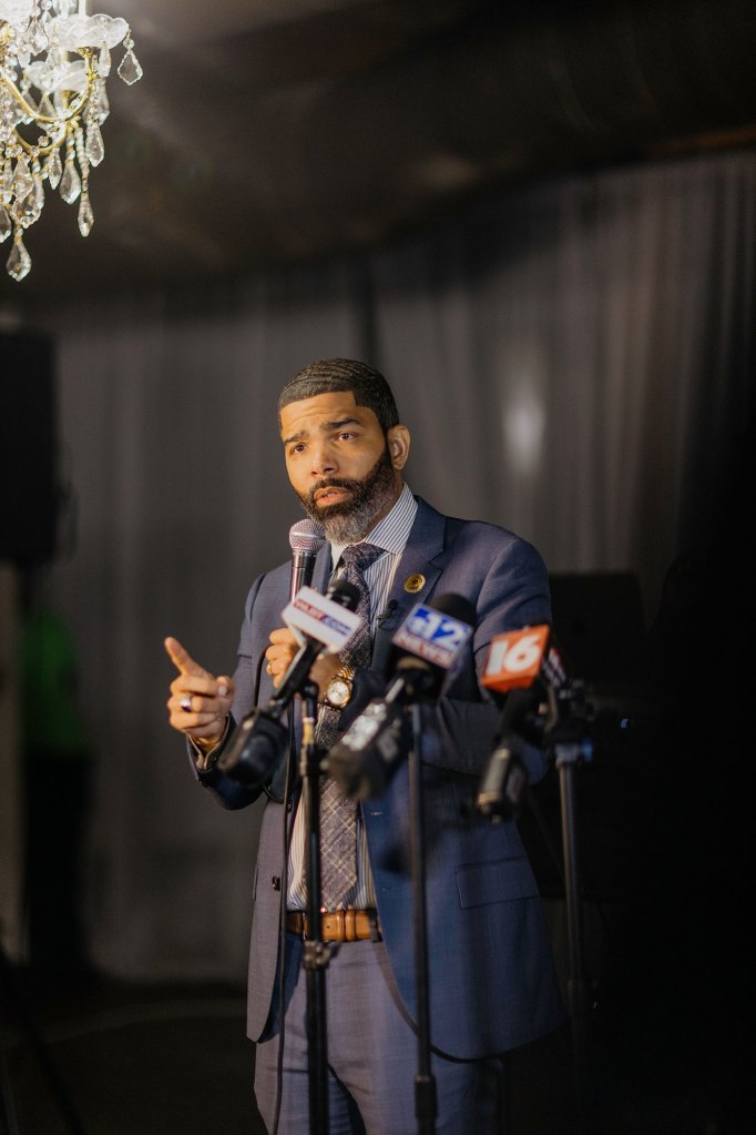 Chokwe A Lumumba in a suit speaking on a stage