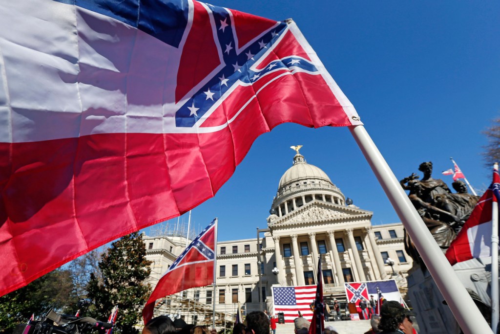 Old Mississippi flag waving in front of the Capitol