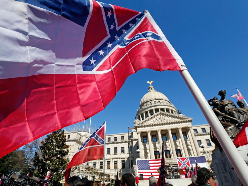 Old Mississippi flag waving in front of the Capitol
