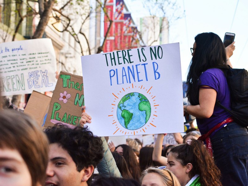 A rally with many people. A central sign reads There Is No Planet B
