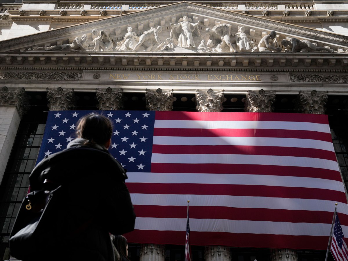 The U.S. flag hangs on the front of a building labeled New York Stock Exhange