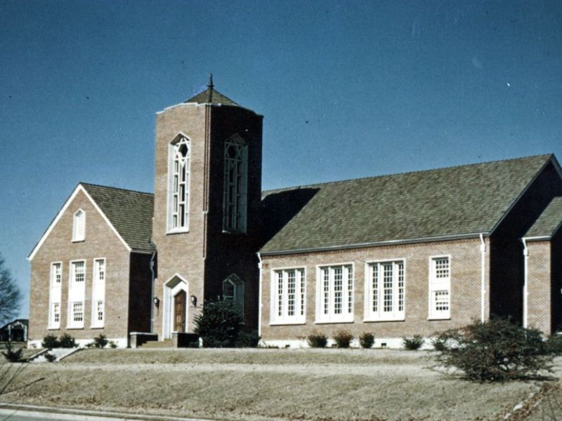 An old color photograph of a brick church building