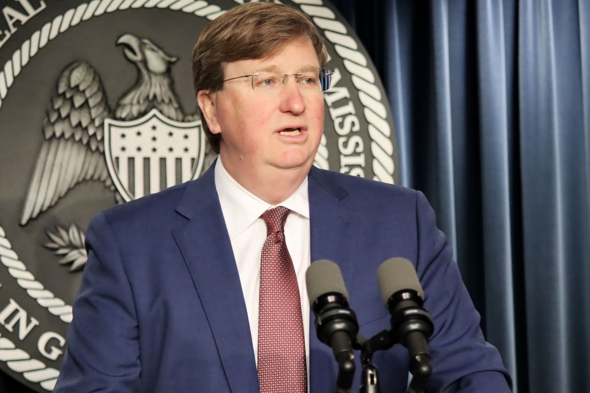Gov. Tate Reeves speaking at a podium.