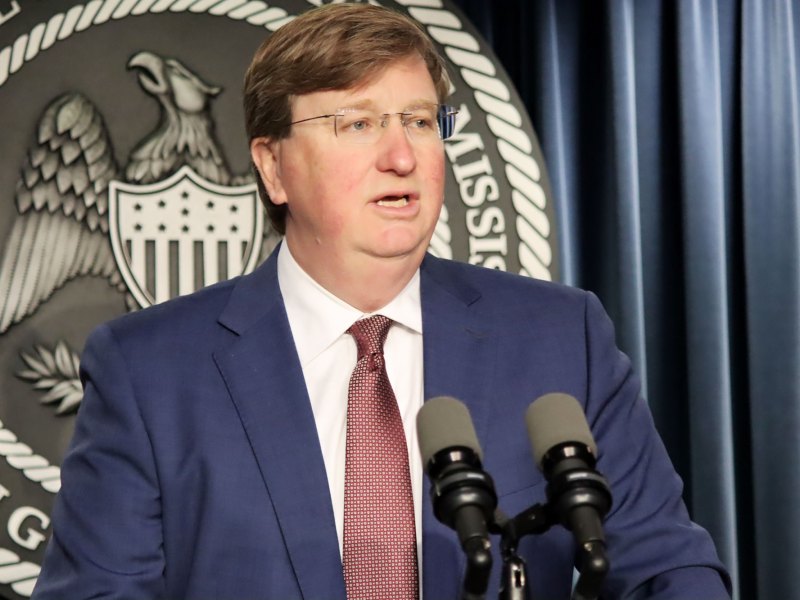 Gov. Tate Reeves speaking at a podium.