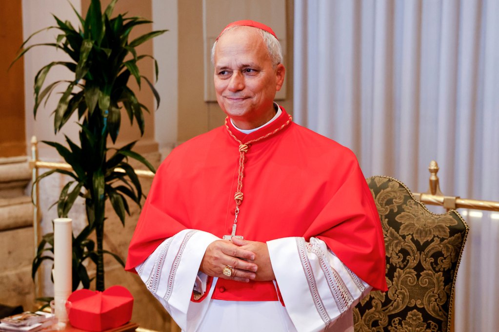 Cardinal Robert Francis Prevost standing in red and white robes