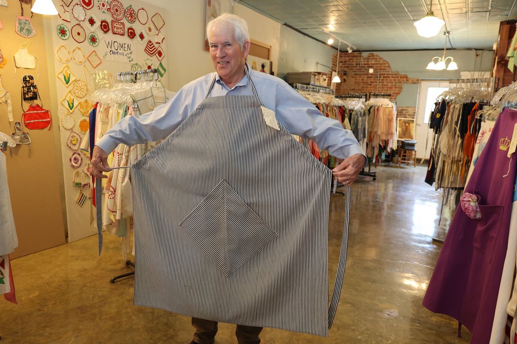 A man holding a very large black and white striped apron