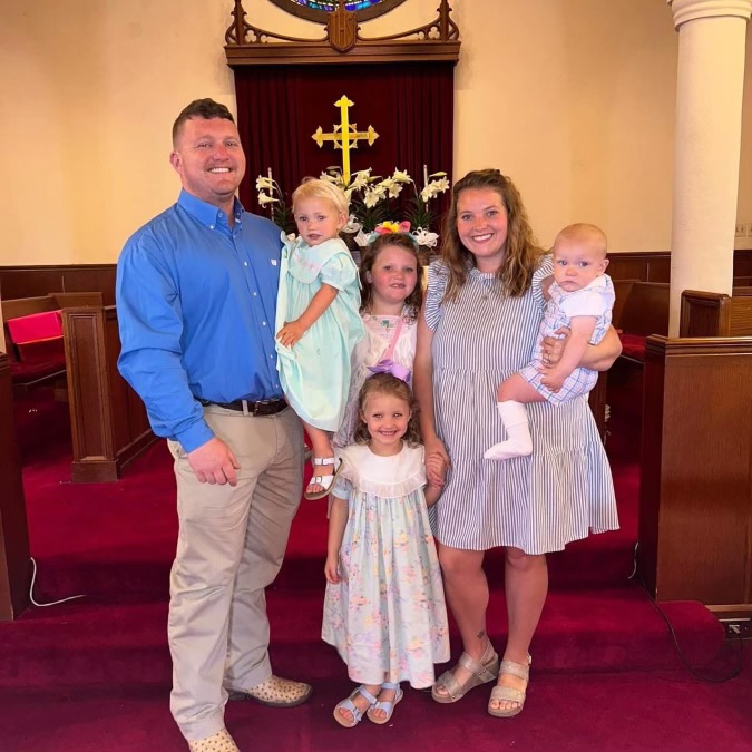 A family of six posed together in a church