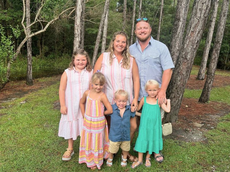 A family of six posed together