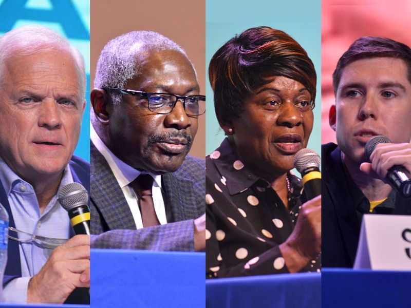 Three men and one woman sit at a table during a candidate event