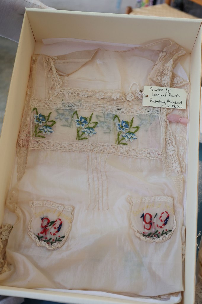 A laced apron with floral prints and 1919 written on it