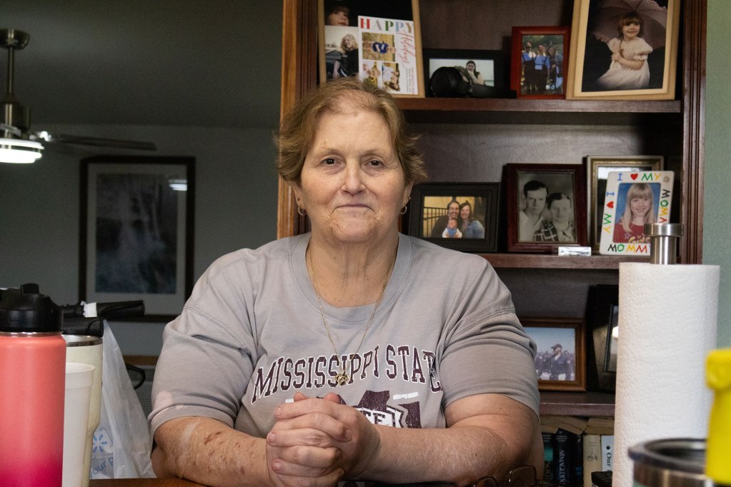 A woman wearing a grey mississippi state t shirt