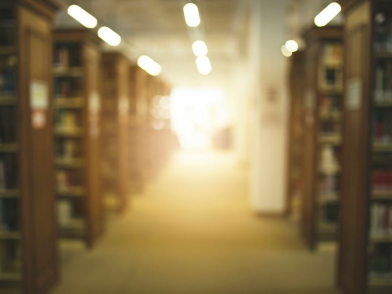 A blurry view of a library full of bookshelves