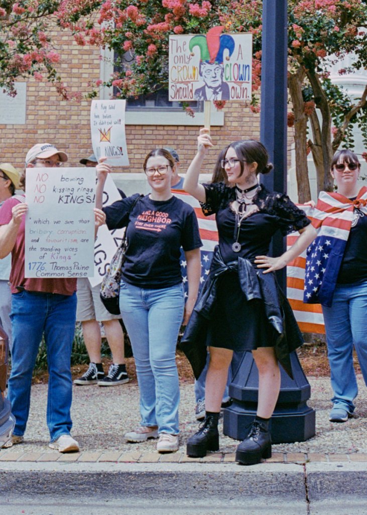 Protesters hold signs that read "The only No kings