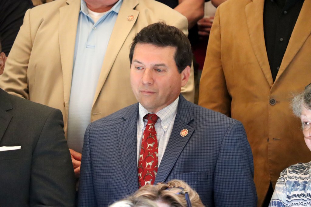 A closeup on Lee Yancey in a crowd of lawmakers