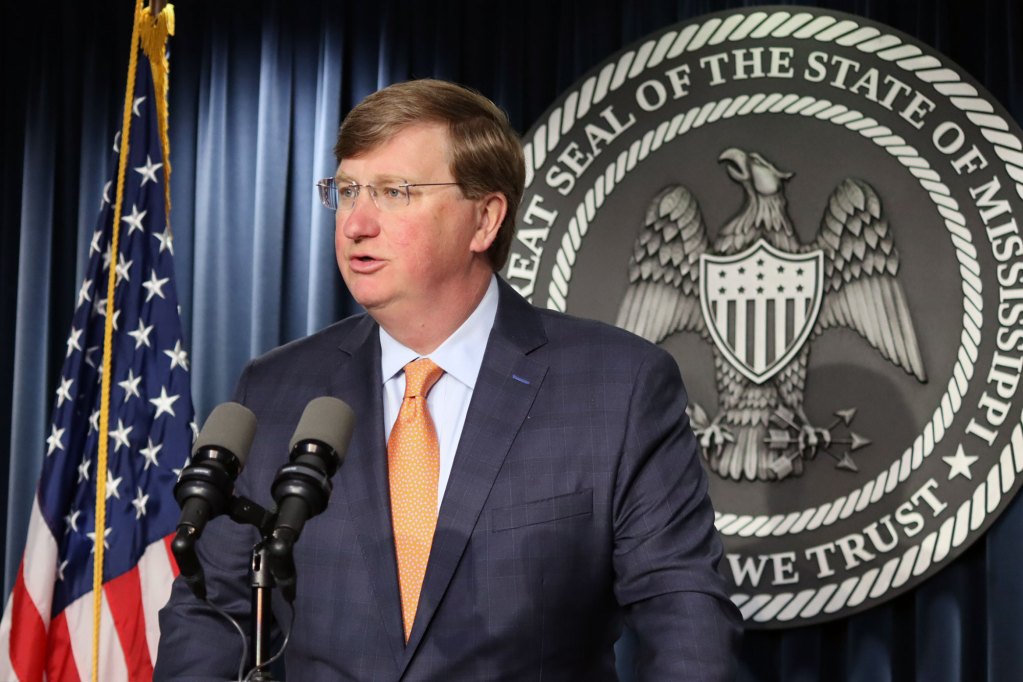 Gov. Tate Reeves speaking at a lectern
