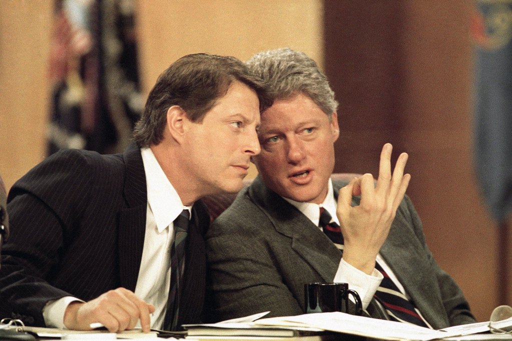 U.S. President Bill Clinton and Vice President Al Gore lean together to talk