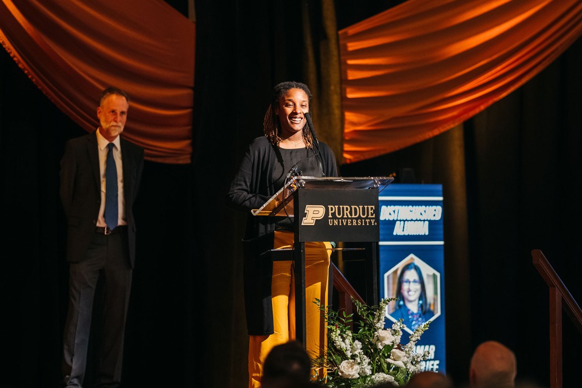 A woman speaking at a podium at Purdue University