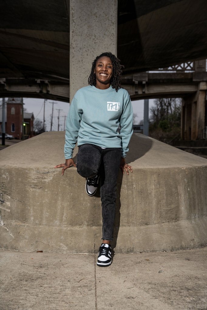 A woman with a long sleeve blue shirt and black pants