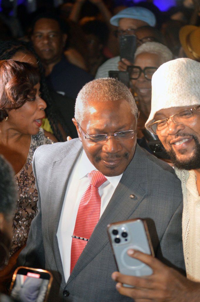 John Hohrn in a crowd of supporters as he poses for a selfie with a person