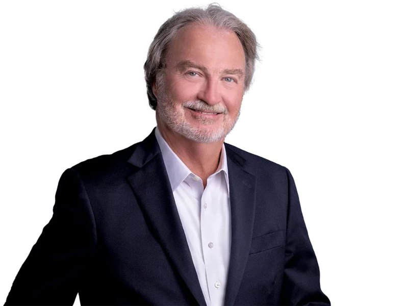 A portrait of Hugh Keating in a suit against a plain white background