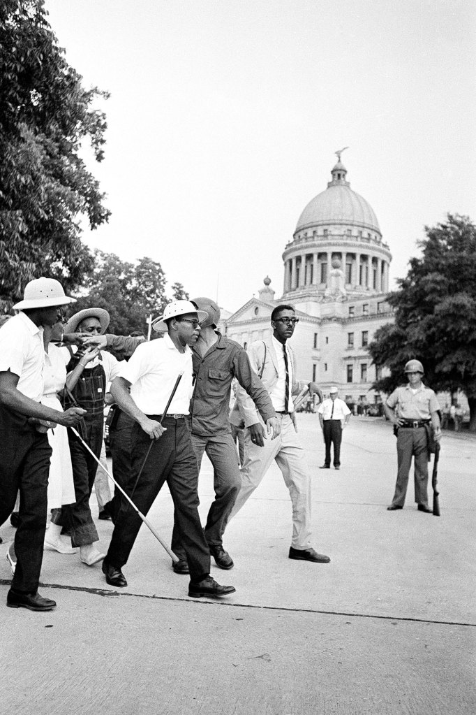 James Meredith and others walk outside of the Mississippi State Capital building