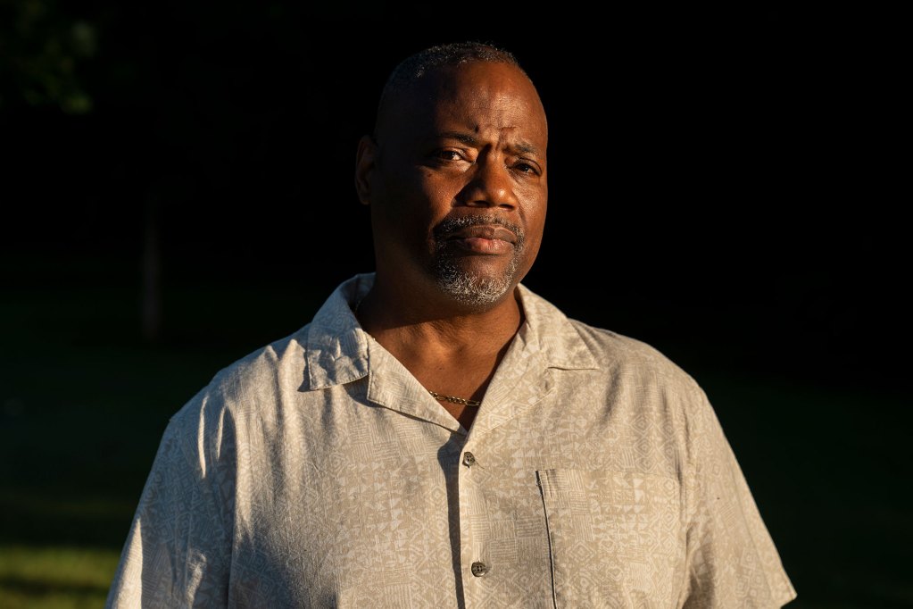 A man poses for a photo at golden hour