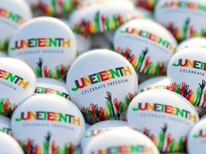 Juneteenth printed badges with images of black, red, green, and yellow hands
