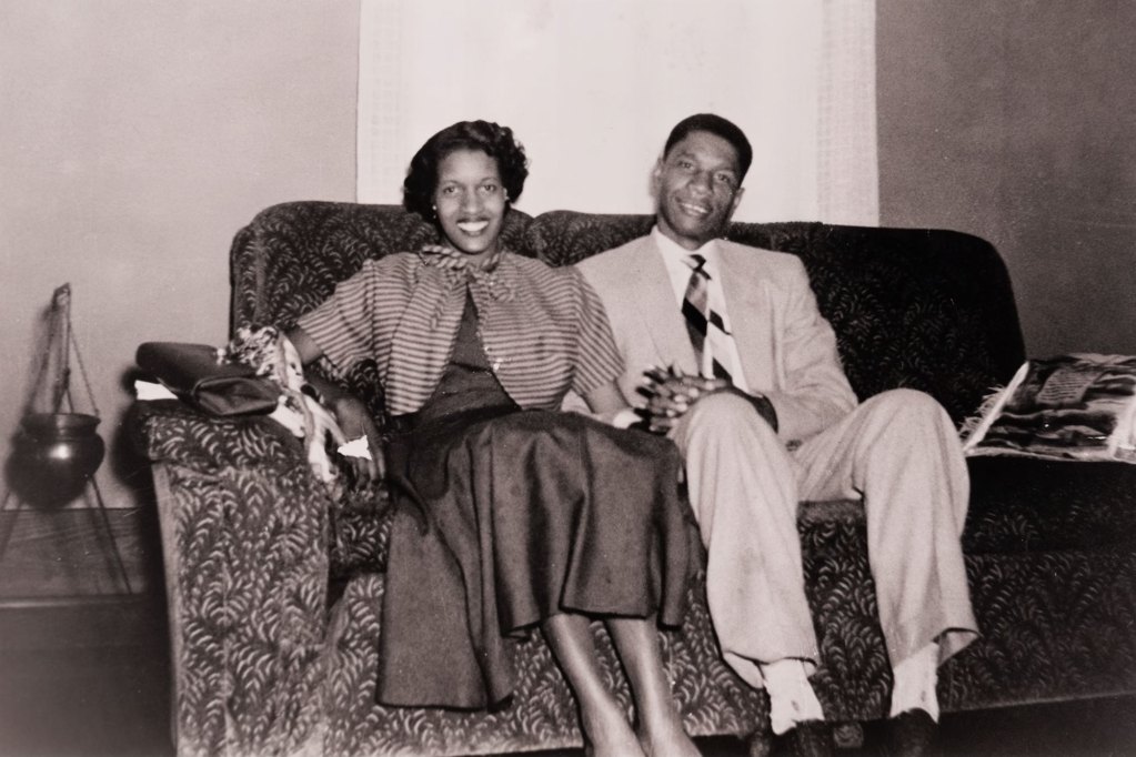Myrlie and Medgar Evers sitting together on a couch