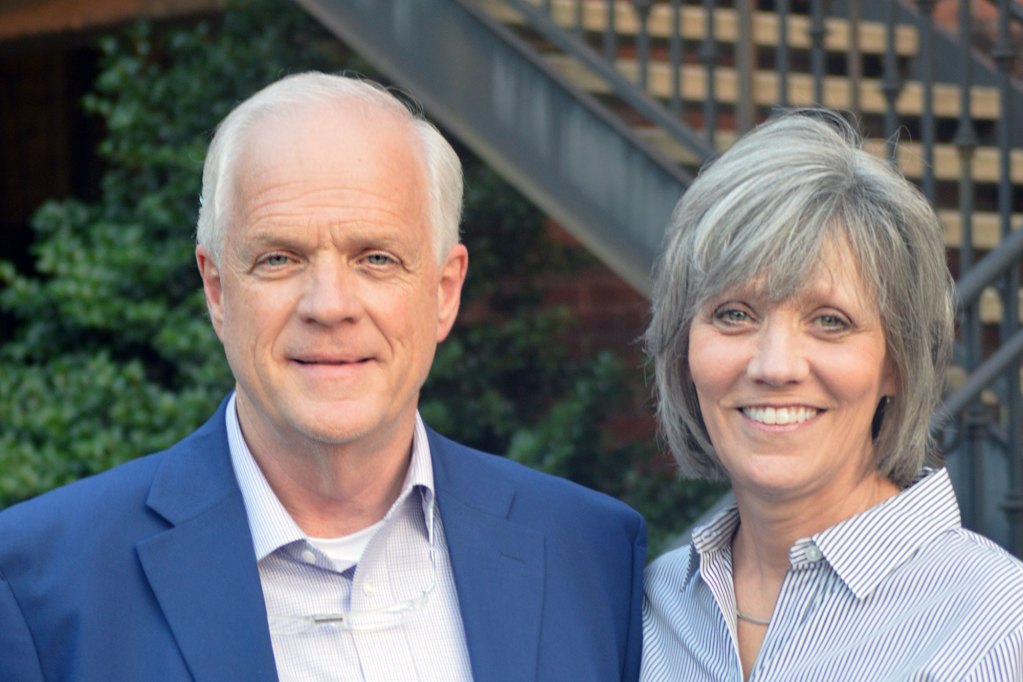 Rodney DePriest and his wife Becki DePriest pose together outside in a couryard