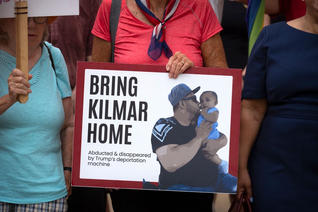 Supporters at a rally holding a sign that reads "Bring Kilmar Home"