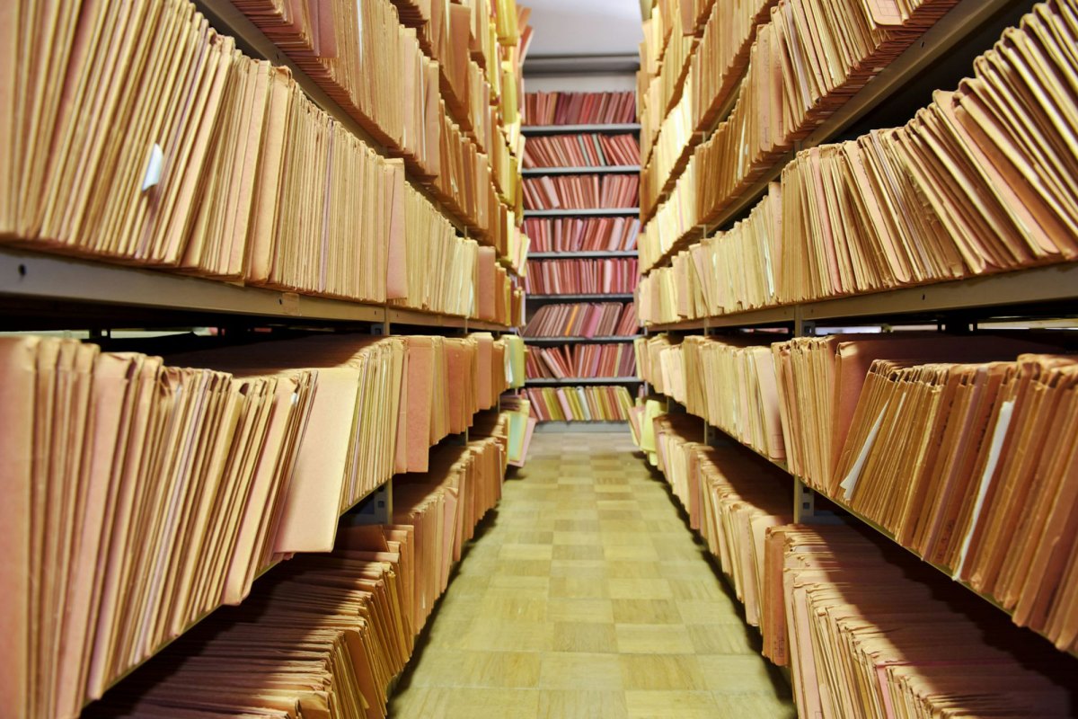 A view of shelves filled with manilla folders of paper