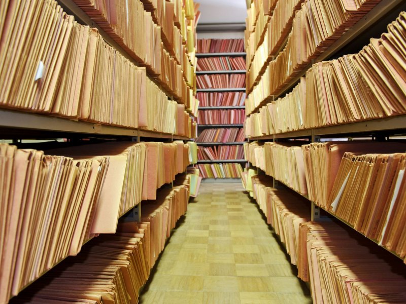 A view of shelves filled with manilla folders of paper