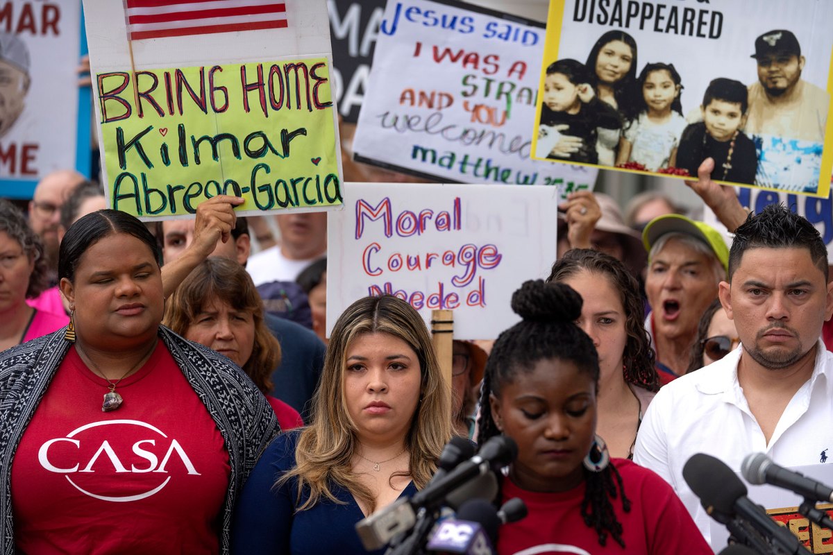 People at a rally with signs that read "Bring Home Kilmar Abrego Garcia"