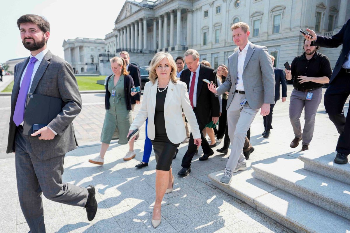 Marsha Blackburn, center, walking out of a building with other lawmakers