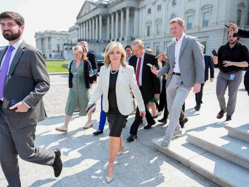 Marsha Blackburn, center, walking out of a building with other lawmakers