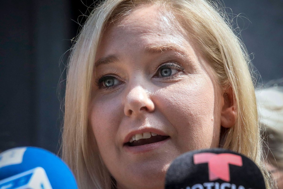 A closeup of Virginia Giuffre speaking at a press conference