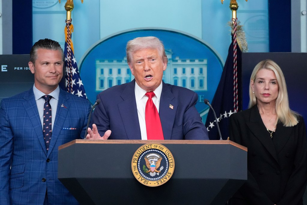Donald Trump speaks at n official White House presser as Pete Hegseth and Pam Bondi look on