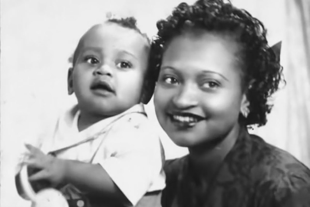 An old black and white photo of Mamie Till Mobley posing with her infant son Emmett Till