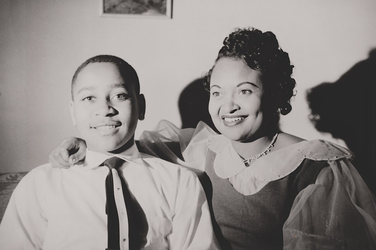 Emmett Till and Mamie Till-Mobley smile in a black-and-white photo.