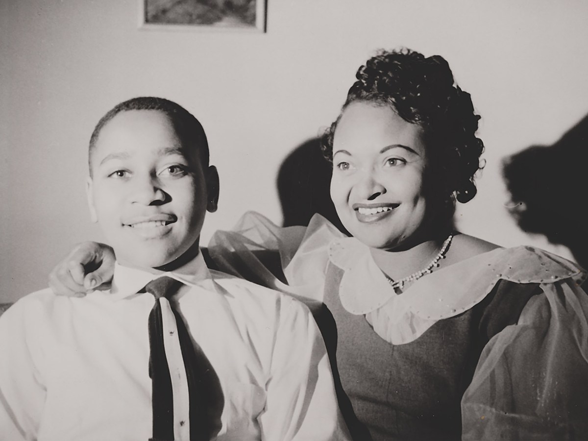Emmett Till and Mamie Till-Mobley smile in a black-and-white photo.