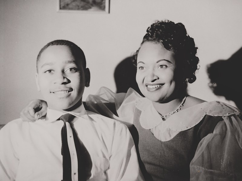 Emmett Till and Mamie Till-Mobley smile in a black-and-white photo.