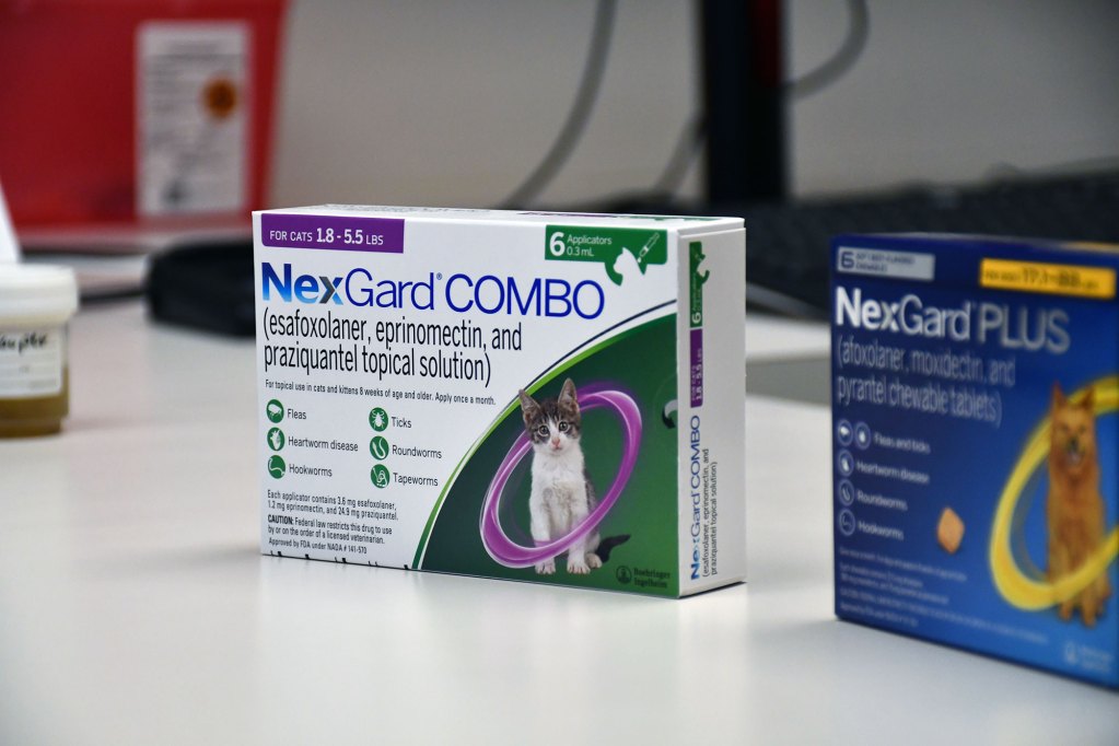 Boxes of heartworm prevention medication on a veterinary exam table.